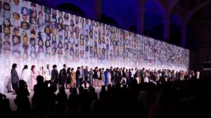 a large group of people standing in front of a wall