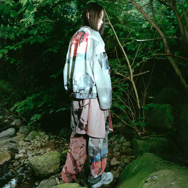 a person standing on a rock in a forest