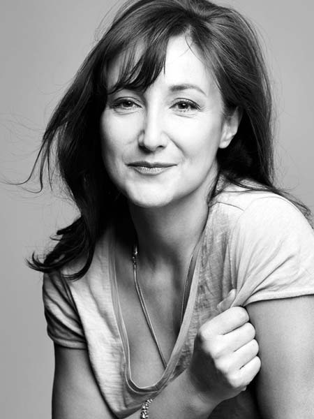 a black and white photo of a woman smiling