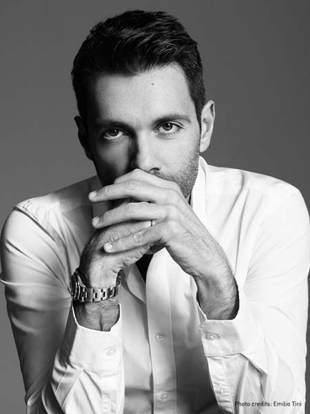 a black and white photo of a man in a white shirt