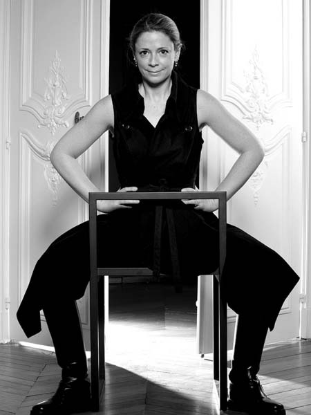 a black and white photo of a woman sitting on a chair