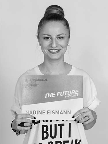 a black and white photo of a woman holding a sign