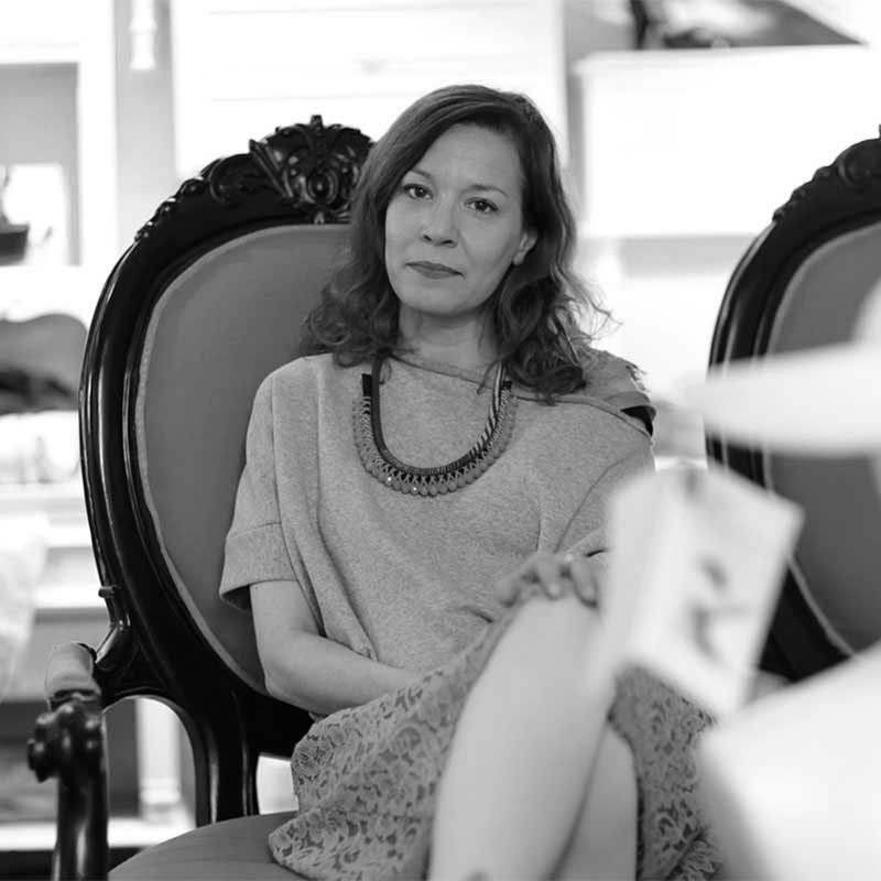 a black and white photo of a woman sitting in a chair