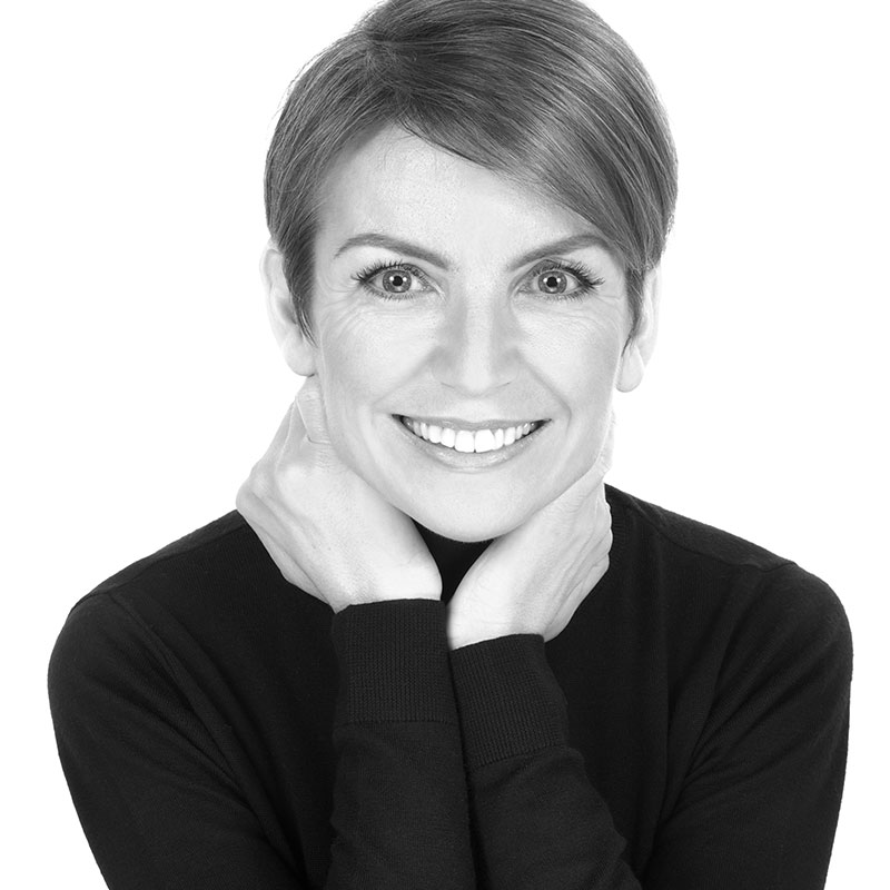 a black and white photo of a woman smiling