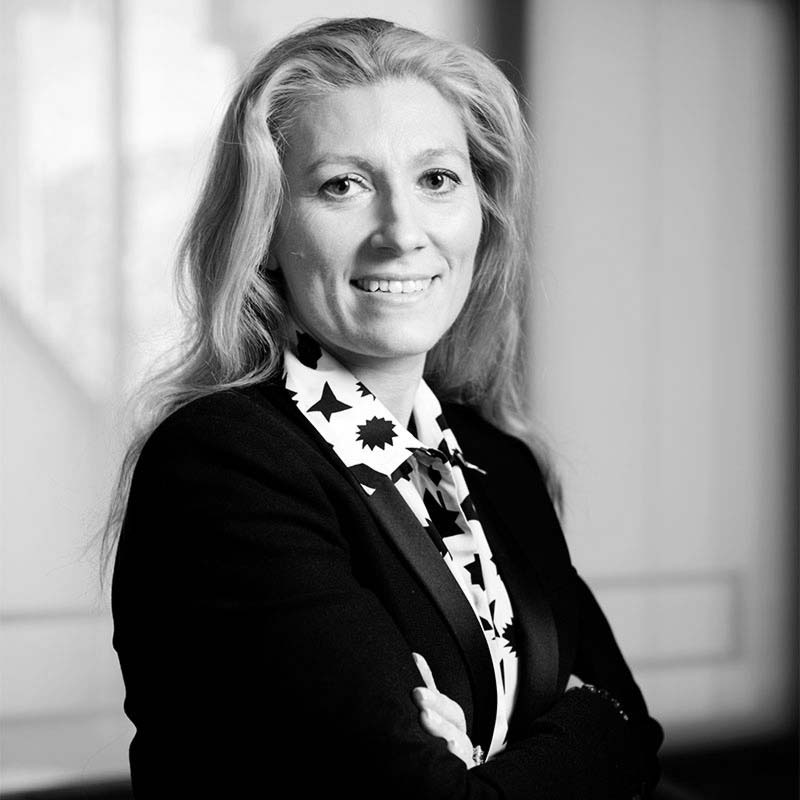 a black and white photo of a woman with her arms crossed