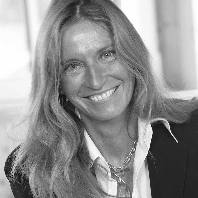 a black and white photo of a woman smiling