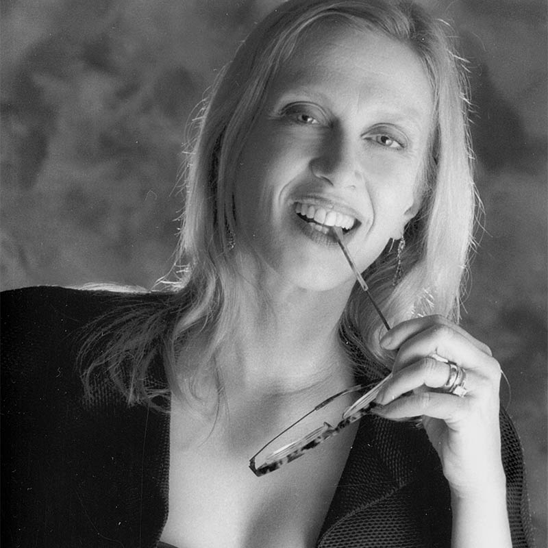 a black and white photo of a woman brushing her teeth