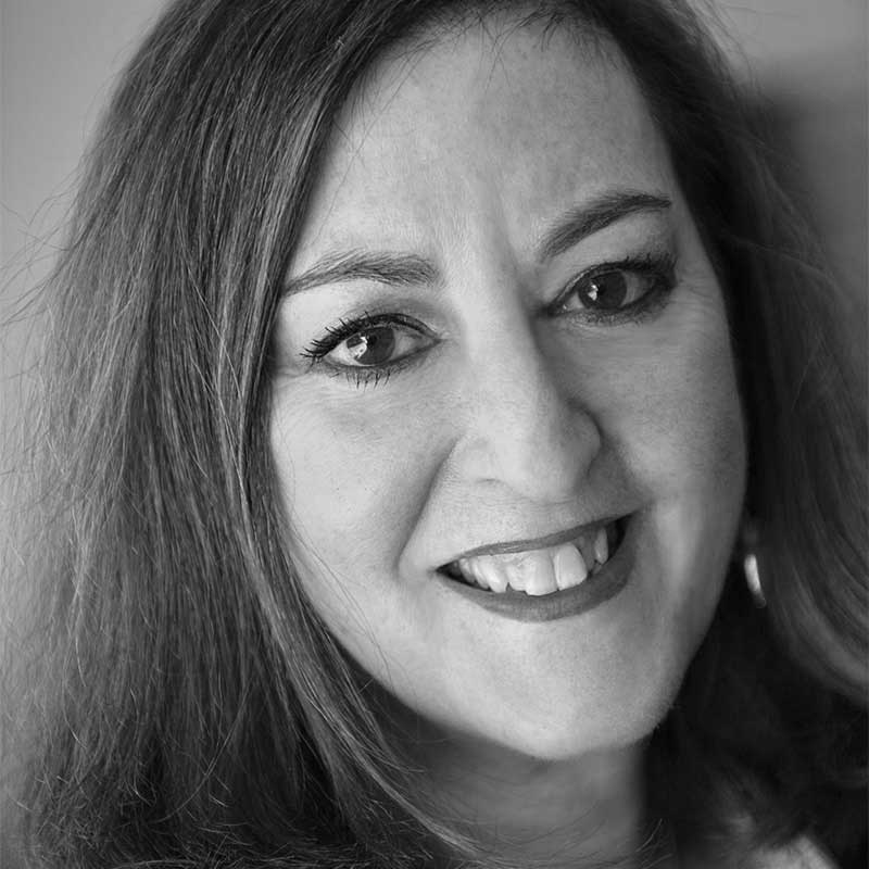 a black and white photo of a woman smiling