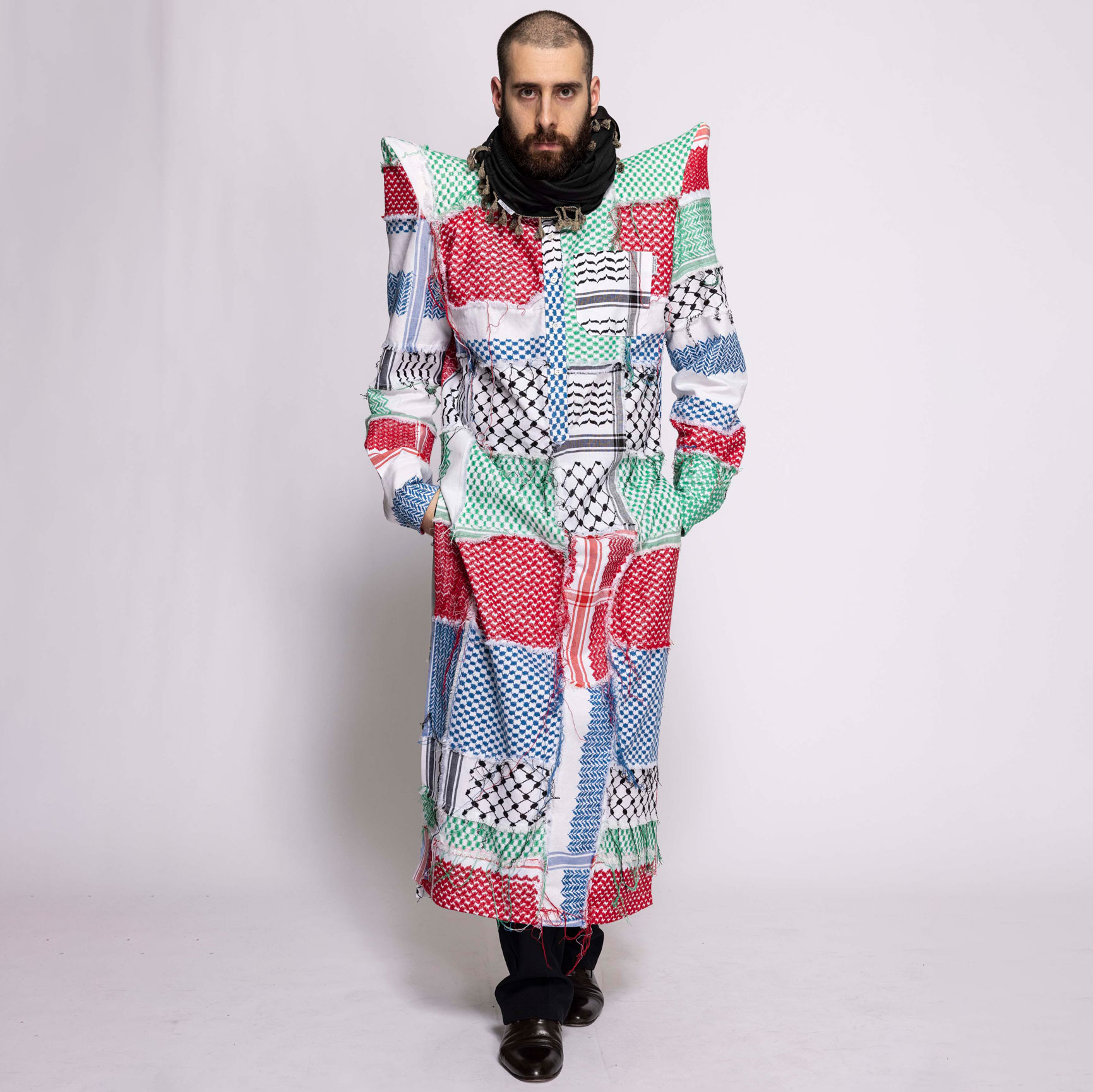 a man with a beard wearing a colorful coat