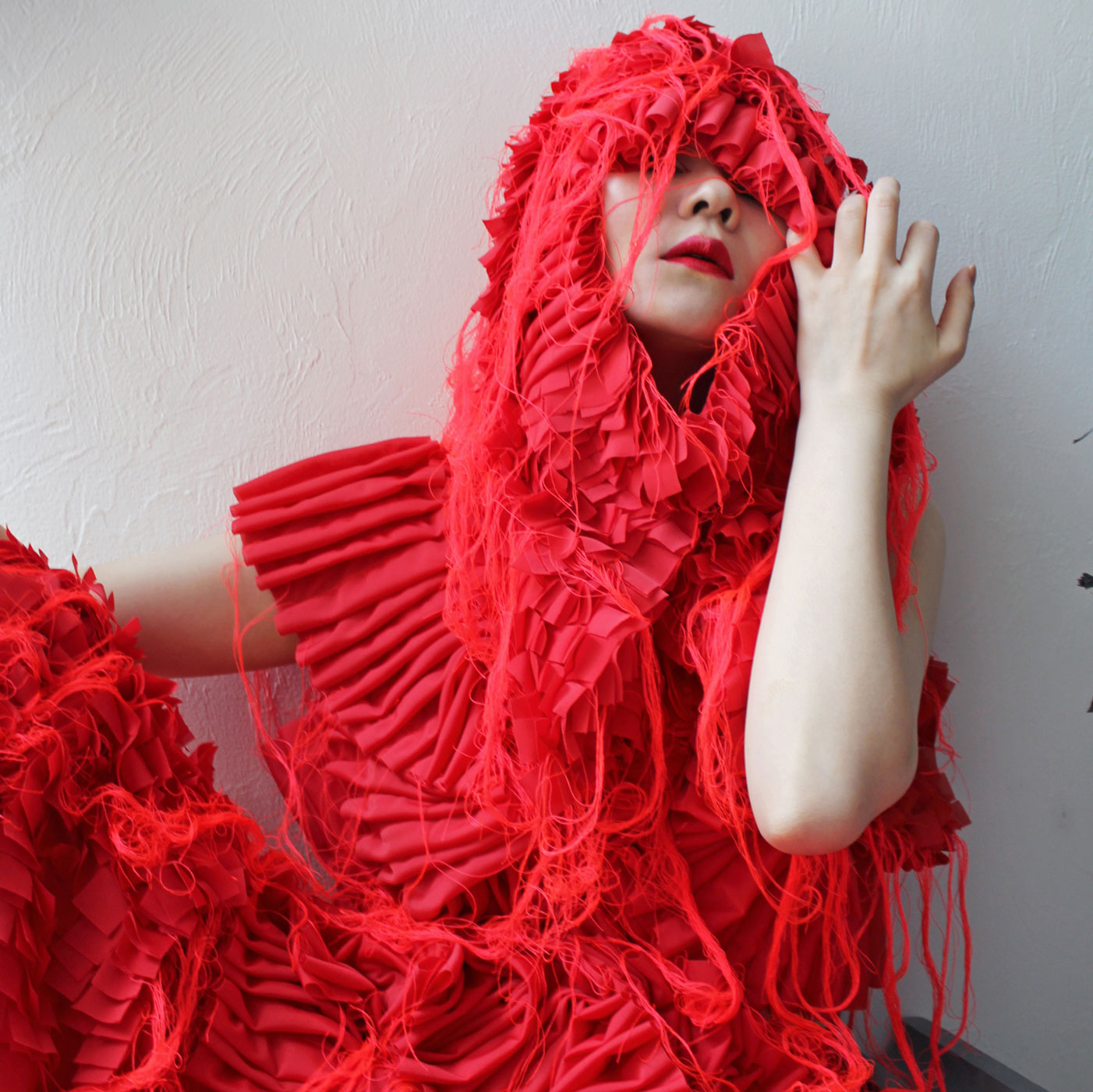 a woman in a red dress sitting on the floor