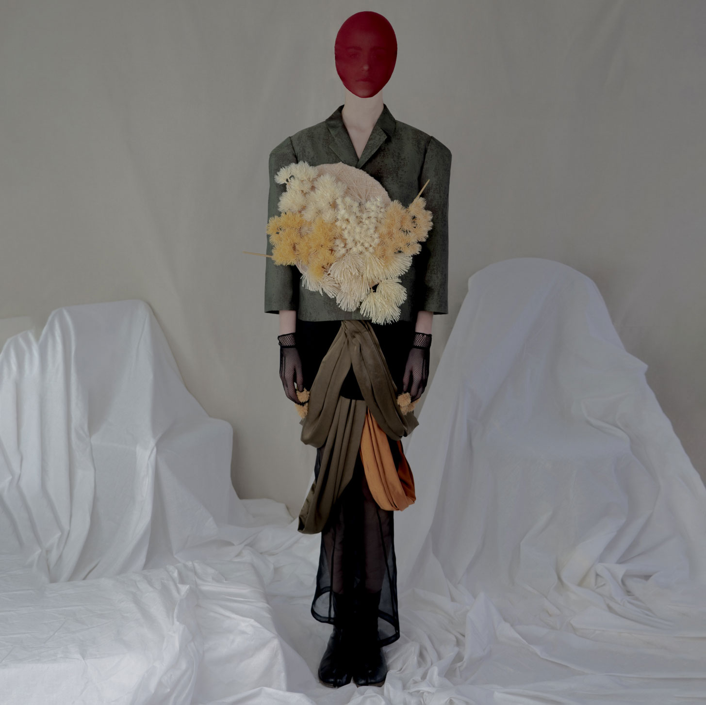 a mannequin wearing a suit and holding a bouquet of flowers