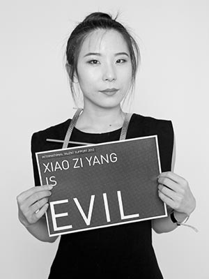 a woman holding a sign that says evil