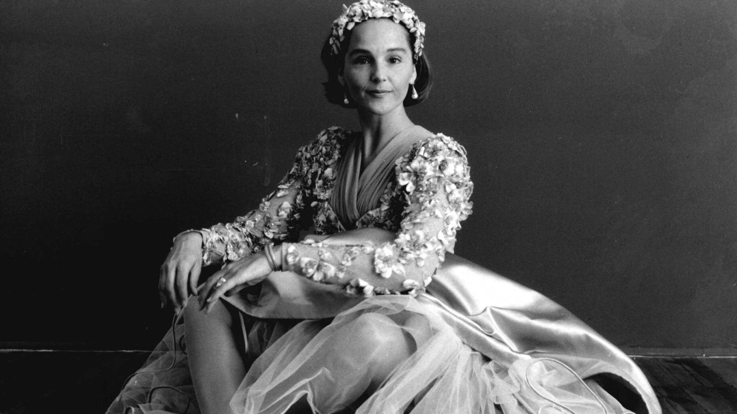 a black and white photo of a woman in a dress