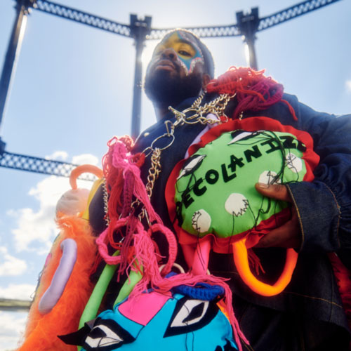 a man holding a bunch of stuffed animals