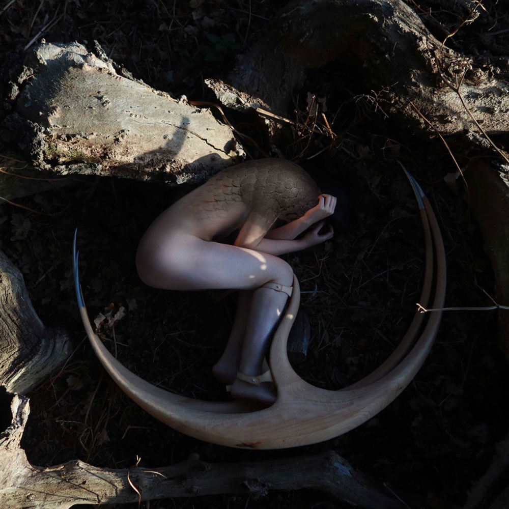 a statue of a woman in a circle on the ground