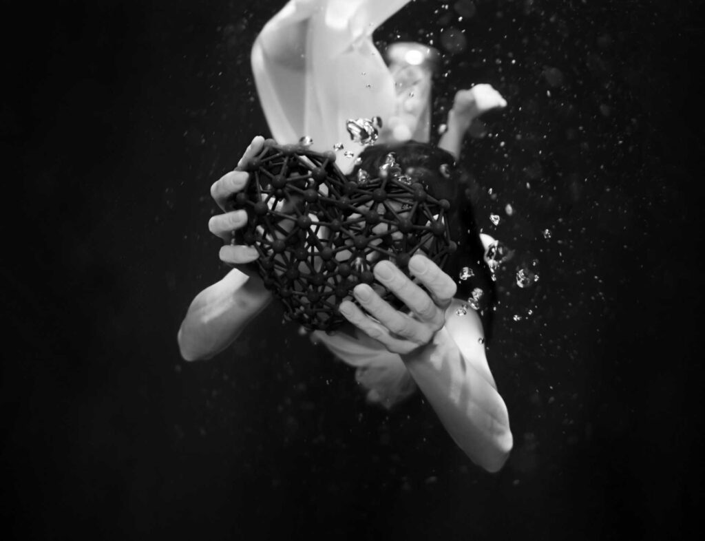 a black and white photo of a woman holding a heart