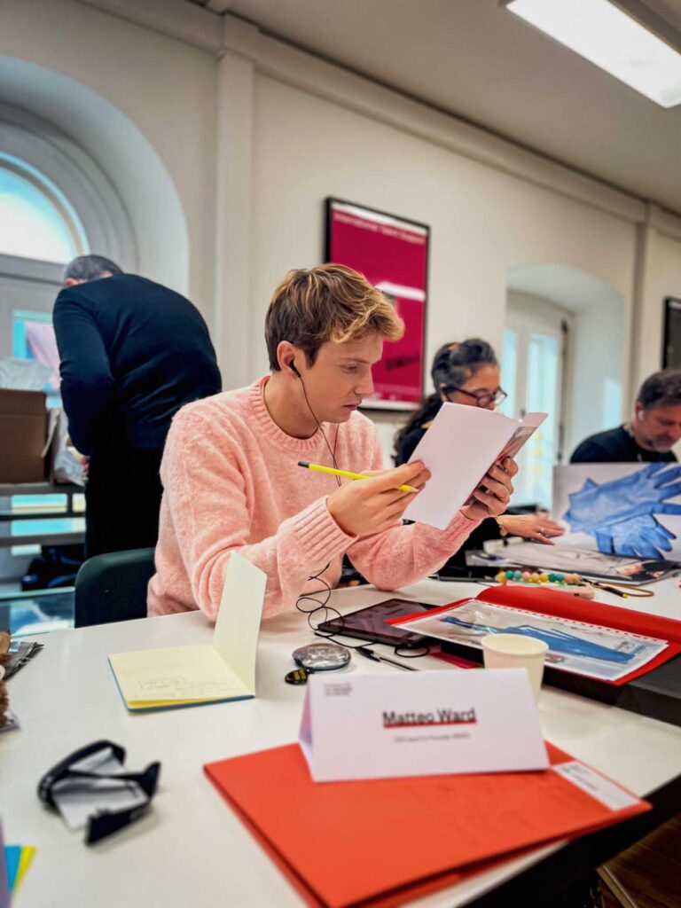 a group of people sitting at a table with papers