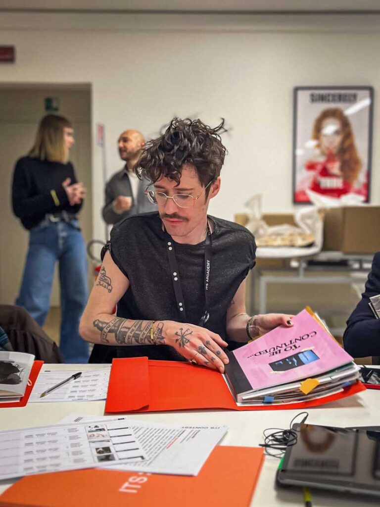 a man sitting at a table reading a book