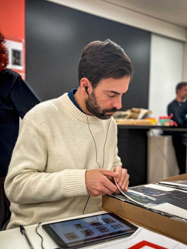 a man sitting at a table with an ipad