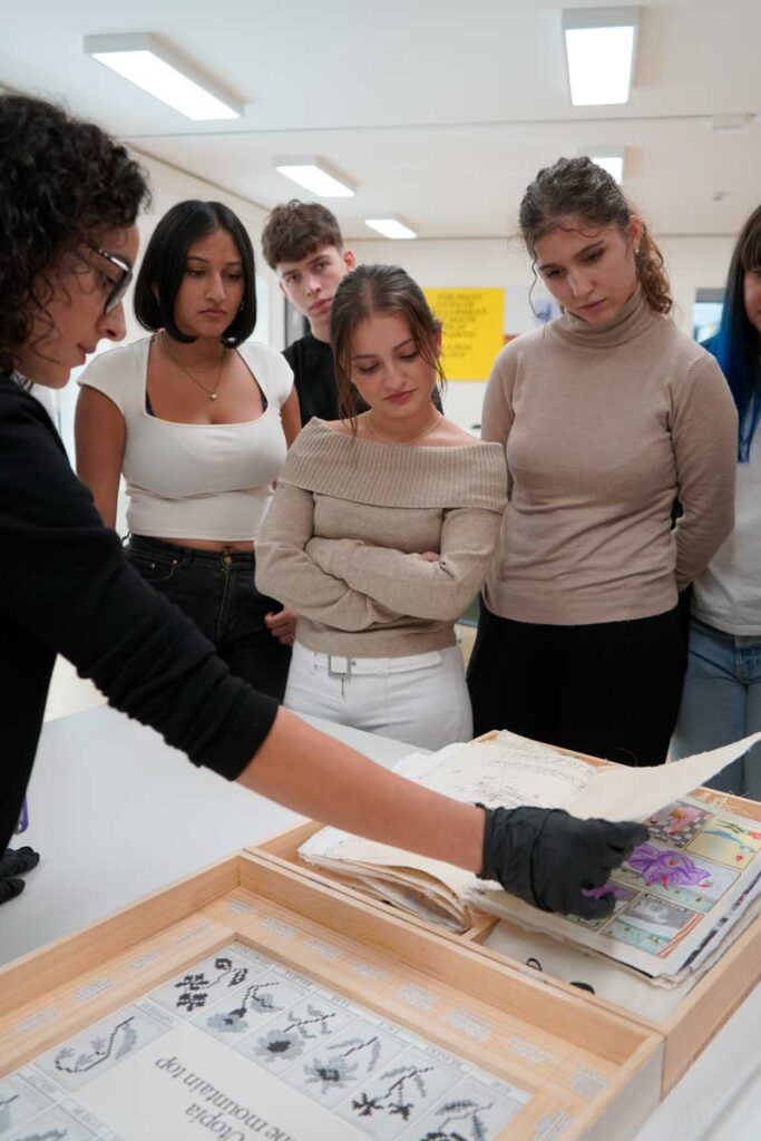 a group of women standing around a table