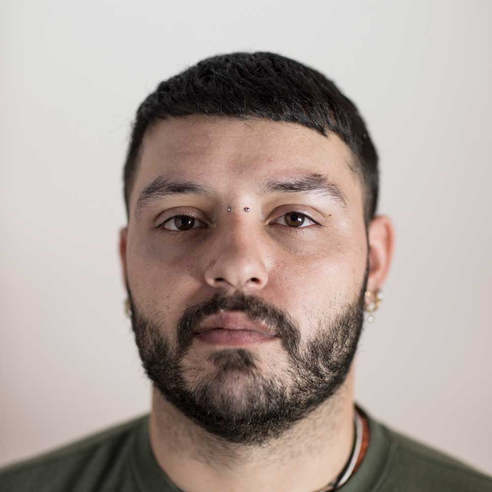 a man with a beard wearing a green shirt