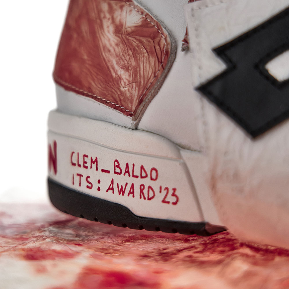 a close up of a white and red sneaker