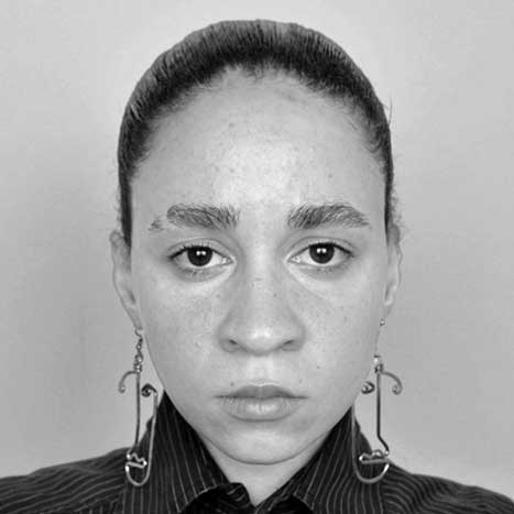 a black and white photo of a woman wearing earrings