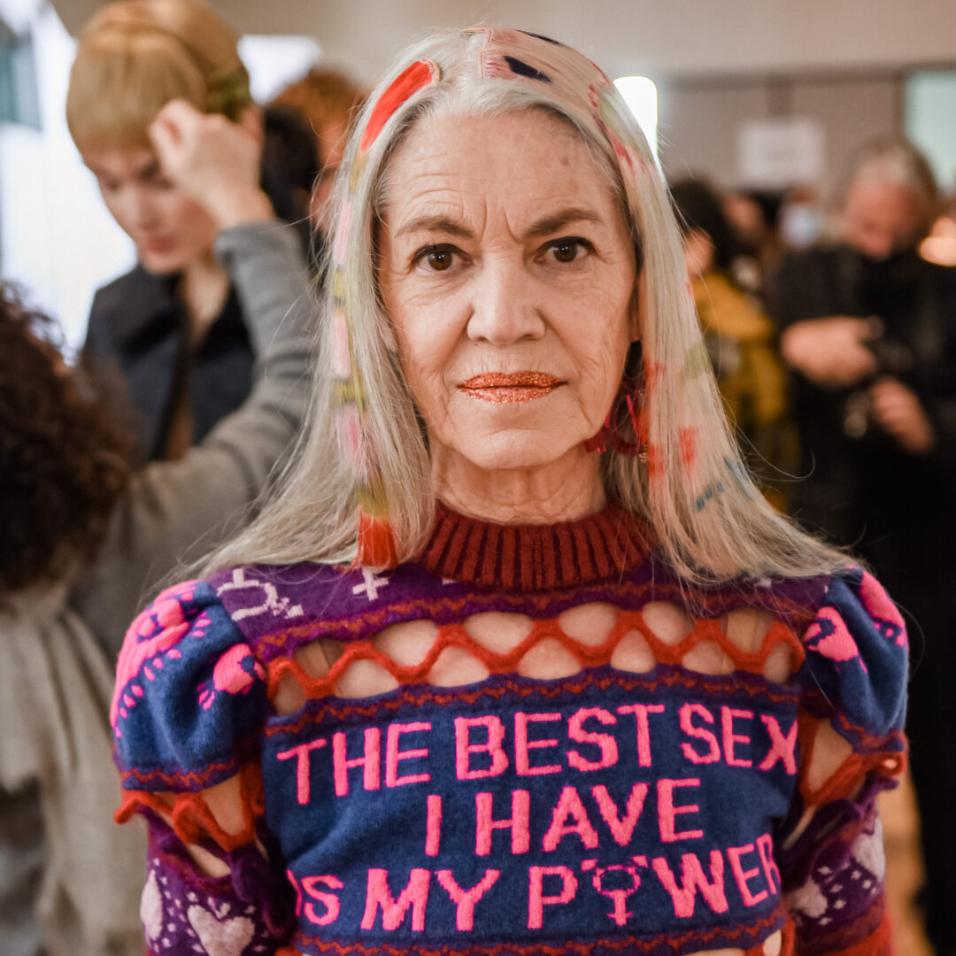 a woman with blonde hair wearing a sweater that says the best sex i have is