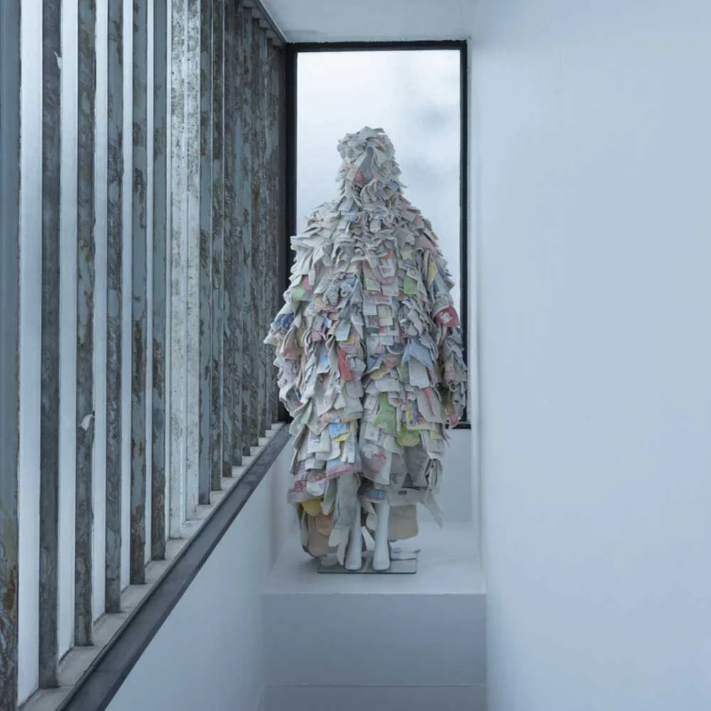 a person is standing on a staircase made out of newspapers