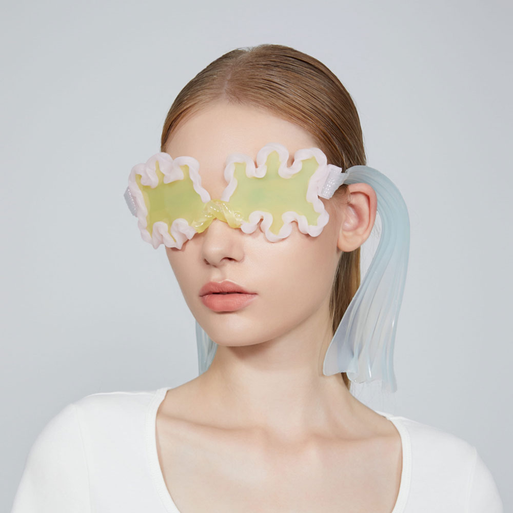 a woman wearing a pair of yellow and white eye masks